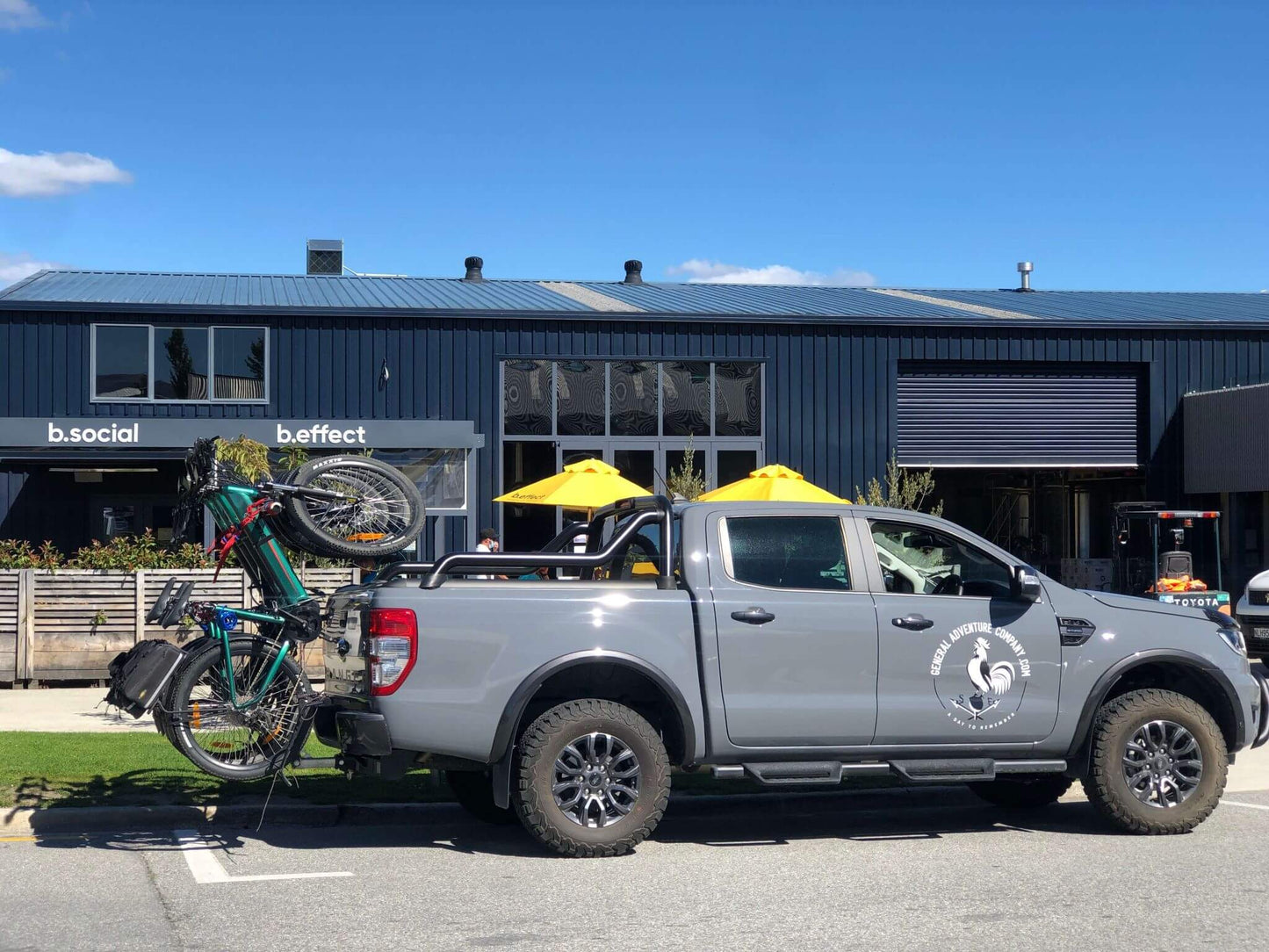 A truck with e-bikes parked outside a brewery in Wanaka