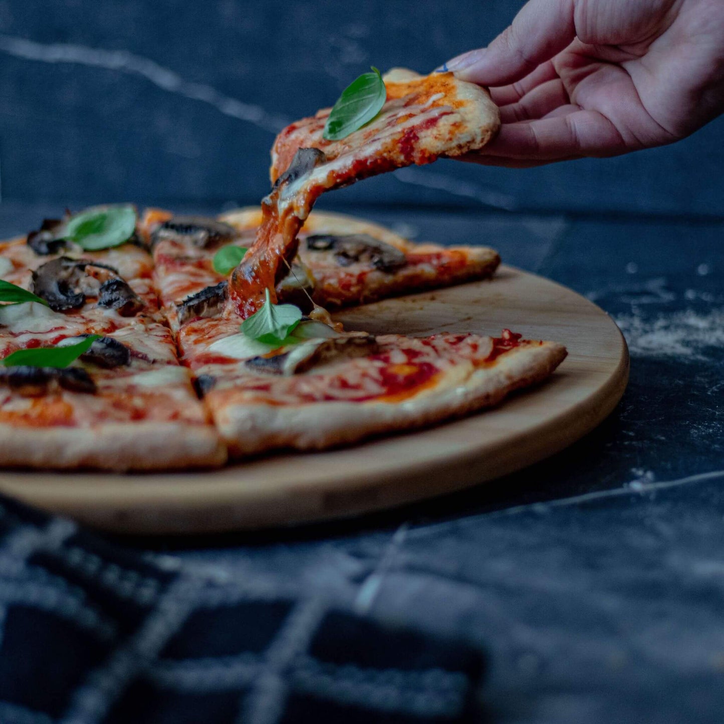 a mushroom and basil pizza slice