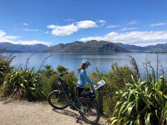 A cyclist checking a map during Hawea River eBike adventure